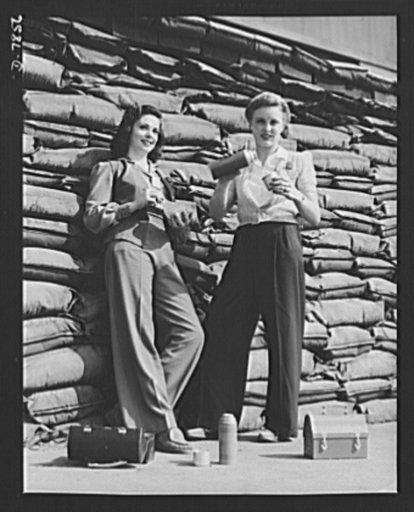 Production. Airplane maufacture, general. Lunchtime brings a few minutes of rest for these women workers of the assembly line at Douglas Aircraft Company's Long Beach, California, plant. Sand bags for protection against air raids form the background. Most important are the many types of aircraft mad