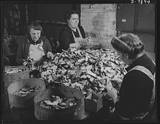 Empty collapsible tubes: a tin mine for war industry. Three housewives with husbands in the service sort empty metal tubes that will be melted down at the Newark, New Jersey plant of the Tin Salvage Institute. These workers separate tin and lead tubes from containers made of other materials. In addi