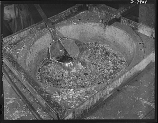 Empty collapsible tubes: a tin mine for war industry. A ladle of almost pure tin, reclaimed from old tooth paste and other metal tubes, is removed from a heating pot for pouring into molds at the Newark, New Jersey, plant of the Tin Salvage Institute. This plant handles about 400,000 pounds of old t