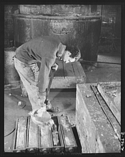 Empty collapsible tubes: a tin mine for war industry. Pouring molten tin, reclaimed from old tooth paste and other similiar metal tubes, into molds at the Newark, New Jersey, plant of the Tin Salvage Institute. Heavy demands from war industries has prompted recovery of tin from collapsible tubes