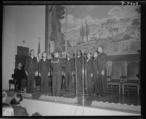 Marian Anderson mural dedicated. Musician (second class) Wayman E. Hathcock, directs a double quartet from Camp Robert Smalls, Great Lakes Training Station, at the dedication of a mural commemorating Marian Anderson's free public concert on the steps of the Lincoln Memorial on Easter Sunday, 1939. T