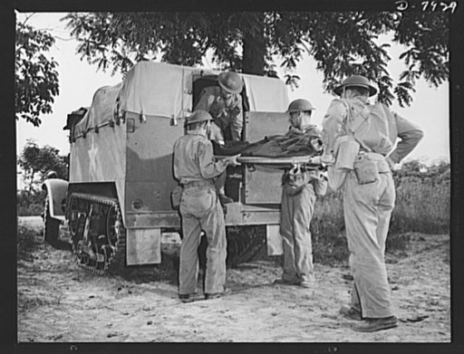 Fort Knox. Halftrac crews. Lifting a "wounded" tank crew member into a halftrac ambulance at Fort Knox, Kentucky. The Fort Knox school for men of the armored service is teaching many American soldiers how to use mechanized striking equipment to best advantage. Its graduates are now on many of our fa