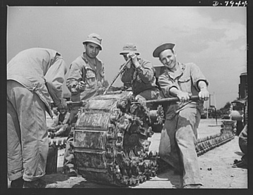 Fort Knox. Maintenance of mechanized equipment. Turning one of the heavy tracks of an M-3 tank at Fort Knox, Kentucky. The Army keeps a large force of trained mechanics busy at the job of servicing and repairing all its motorized equipment