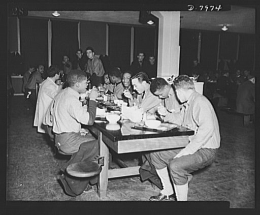 Manhattan Beach Coast Guard training station. An important part of the four weeks intensive course at the Manhattan Coast guard training station is spent at the training table. The best of food and plenty of it is served the men to build them up physically for the arduous tasks awaiting them