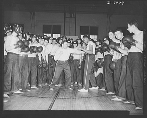 Manhattan Beach Coast Guard raining station. Boxing is compulsory in the four-week intensive course at Manhattan Beach Coast Guard training station. Lou Ambers, former world's lightweight contender, show a class of enrollees how to lead and block punches
