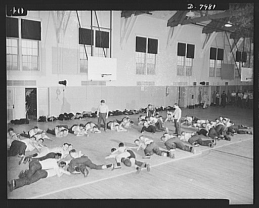 Manhattan Beach Coast Guard training station. A modified form of "commando" tactics is part of the physical training course for enlistees at Manhattan Beach Coast Guard training station. Jim Walker, former Iowa University football star, is shown demonstrating wrestling holds to a gym class at Manhat