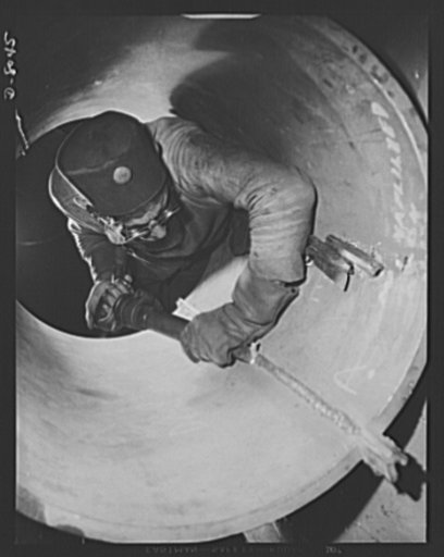 Production. Steam power plant equipment. Excess metal is chipped away on a welded seam on the inside of a high-pressure boiler drum. Steam boilers and other power-house equipment to supplement the hydroelectric installations of the Tennessee Valley Authority (TVA) system are produced in the large Ch
