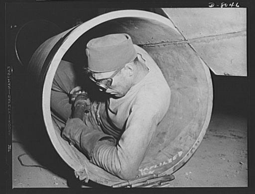 Production. Steam power plant equipment. Excess metal is chipped away on a welded seam on the inside of a high-pressure boiler drum. Steam boilers and other power-house equipment to supplement the hydroelectric installations of the Tennessee Valley Authority (TVA) system are produced in the large Ch