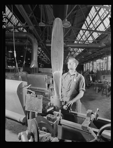 Production. Airplane propellers. John Sonesen, propeller blade grinder at a Hartford, Connecticut plant, inspects a blade for a vertical balance during the operation of grinding it to correct contours in a template. This blade will be assembled in a hydromatic mechanism to help power one of our new 