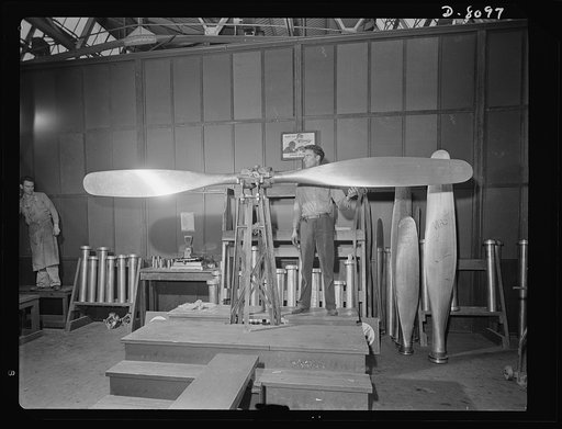 Production. Airplane propellers. Arthur Voss performs final blade balancing tests on a Hamilton airplane propeller at a Hartford, Connecticut, plant. This propeller, which will help to power one of our new warplanes, must be balanced and adjusted to the utmost detail to fit it for the important duty