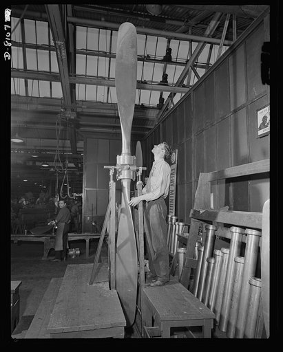 Production. Airplane propellers. Ed Dimlow, makes a final inspection of a two-blade airplane propeller in the vertical position. The Hartford, Connecticut, plant that produces these blades supplies them to our air forces in combinations with two, three or four blades, and with hydromatic mechanisms 