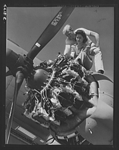 Production. C-47 transport planes. This young woman has become one of the excellent airplane engine mechanics of the Long Beach, California, plant of Douglas Aircraft Company. Here she is learning some of the finer points of the mighty engines that power the C-47 transport plane. The versatile C-47 