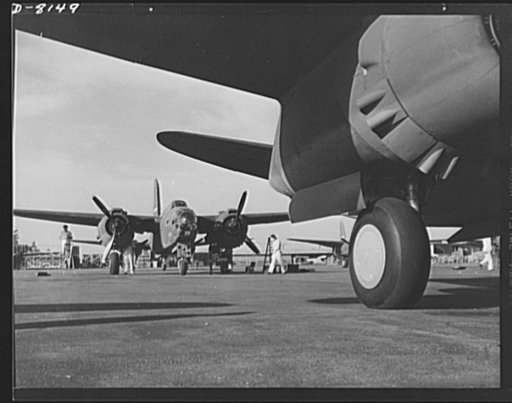 Production. A-20 attack bombers. Mechanics on the flight ramp on the Douglas Aircraft Company at Long Beach, California, check final adjustments on an A-20 attack bomber just before delivery to the Army. The A-20 is used by the American Air Force and Royal Air Force (RAF) for hedge hopping and straf