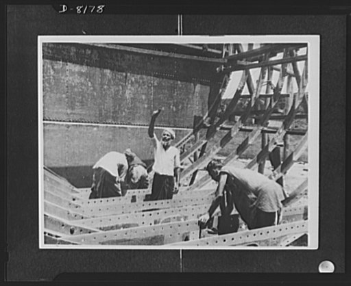 Indian troops in East Africa. These photos show scenes in Indian shipyards busy turning out trawlers and other Naval craft. The floor is being fitted in one of the many new trawlers which are being built for India's defence. The Serang is directing lifting operation