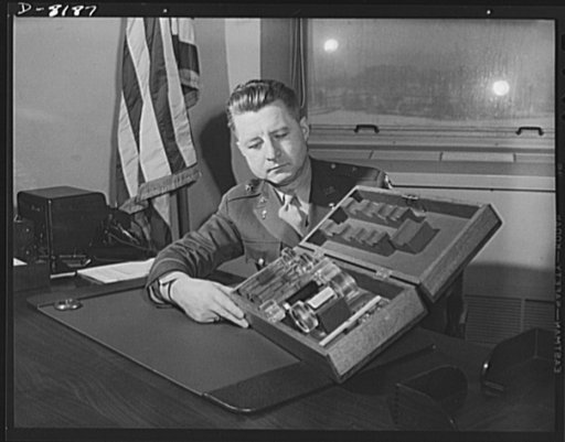 Conservation. Glass gauges replacing steel. Brigadier General H.F. Safford, Chief of theProduction Service Branch, Ordnance Department, examines an exhibit of standard types of new glass gauges which replace steel gauges at the Frankford Arsenal. Glass gauges are lighter and cheaper than steel, perm