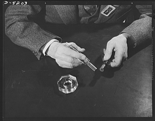 Conservation. Glass gauges replacing steel. A steel plug gauge is compared with a glass plug gauge which replaces it at the Frankford Arsenal. A plain ring glass gauge shows in the foreground. Glass gauges are lighter and cheaper than steel, permit greatly visibility in inspection, are not as much a