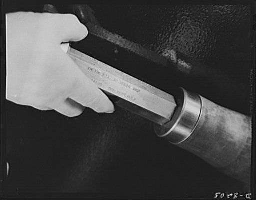 Conservation. Glass gauges replacing steel. A steel plug gauge, since replaced by a glass gauge at the Frankford Arsenal, is shown checking an inside diameter of a cartridge case. Glass gauges are lighter and cheaper than steel, permit greater visibility in inspection, are not as much affected by ro