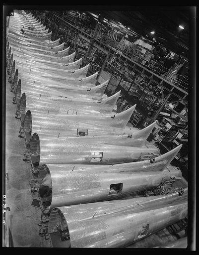 Production. B-17 heavy bomber. Tail sections of B-17F (Flying Fortress) bombers ready for assembly into the big warships of the air at the Boeing plant in Seattle. The Flying Fortress has performed with great credit in the South Pacific, over Germany and elsewhere. It is a four-engine heavy bomber c