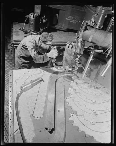 Production. B-17 heavy bomber. Parts for a new B-17F (Flying Fortress) bomber are cut on a routing machine in the Boeing plant in Seattle. The Flying Fortress, a four-engine heavy bomber capable of flying high altitudes, has performed with great credit in the South Pacific, over Germany and elsewher
