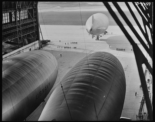 U.S. Navy starts out on patrol duty. A blimp of the U.S. Navy is led onto the apron of an East Coast lighter-than-air station before taking off on a patrol flight over the Atlantic Ocean