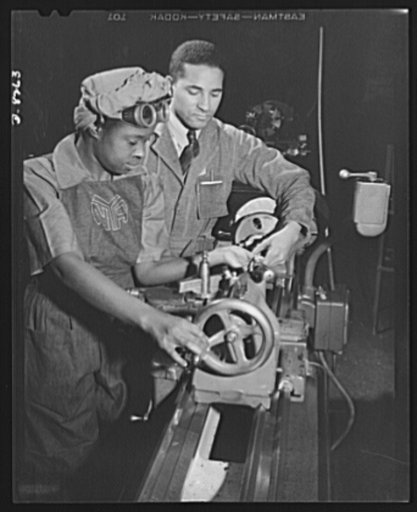 From National Youth Administration to Washington navy yard. Under the direction of Cicil M. Coles, NYA foreman, Miss Juanita E. Gray learns to operate a lathe machine at the Washington, D.C. National Youth Adminstration War Production and Training Center. This former domestic worker is one of the hu