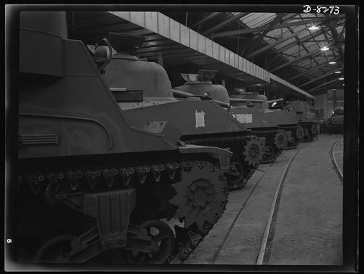 Production. M-4 tanks. M-4 tanks and M-7 mobile howitzer carriages roll off the production lines of the American Locomotive Company in Schenectady, New York. A portion of an M-7 shows in the right foreground, followed by three M-4's and another M-7