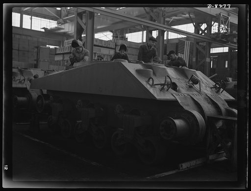 Production. M-4 tanks. Arc welders work on the partly-completed hull of a new M-4 tank at the Schenectady, New York, plant of the American Locomotive Company. M-7 mobile howitzer carriages are also produced in this plant