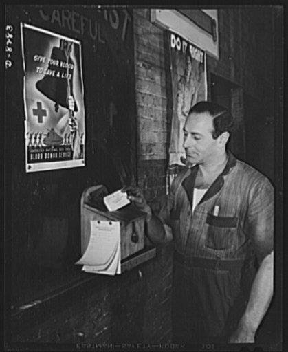 Winner of the plant suggestion award. David Danzig, an employee of American Locomotive Company, Schenectady, New York, drops his suggestion for improving efficiency in the plant's suggestion box