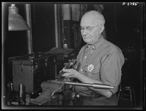 Production. M-4 tanks. Arthur Hale, tool maker with the American Locomotive Company for forty years, is shown upsetting a reamer as part of his successful method for saving time and tool loss. The reamers used in producing combat tanks at the company's Schenectady, New York, plant, work to such clos