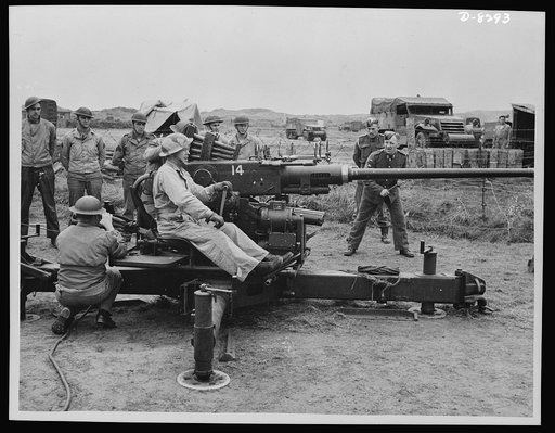 British Sergeant instructs U.S. gunners. A British Sergeant taking some of the U.S. troops in Northern Ireland through a course of light A.A. gun drill