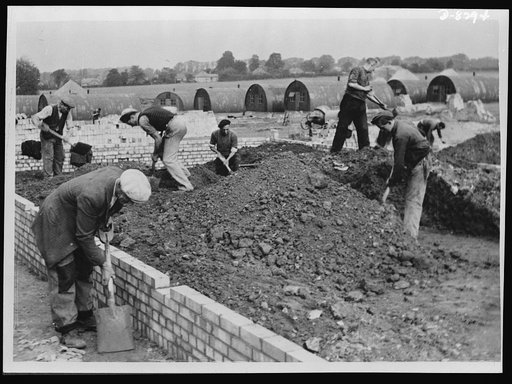 Building a new Army camp at top speed. New camps are being built with great rapidity all over the country to house not only Britain's rapidly expanding Army, but the thousands of U.S. and Canadian troops now arriving. The work is done by civilian contractors, but the Army garrison engineer is in con