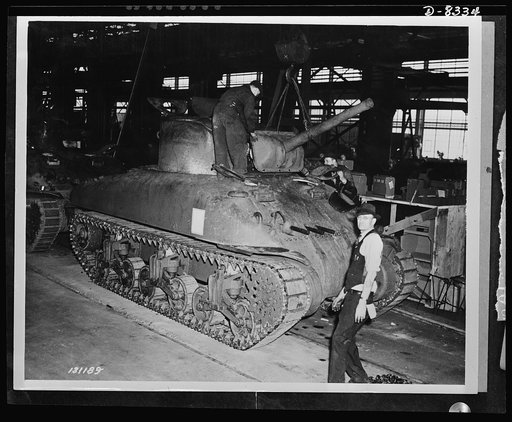 Production. M-4 tanks. Cannon and front turret armored plate are lowered into place on an M-4 tank. Machine guns have already been installed and the General Sherman will be ready for the test track. Designed by the Army Ordnance Department and built under ordnance supervision, the M-4 embodies new a