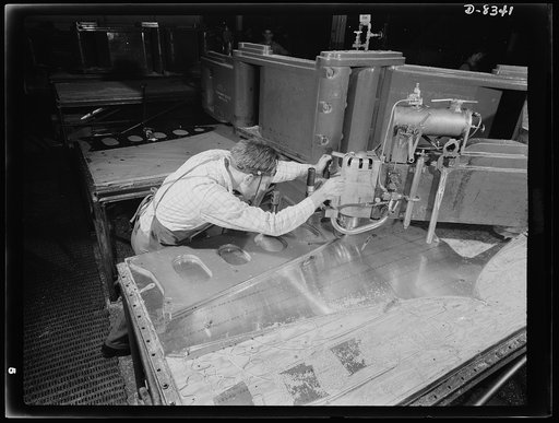Production. B-17F heavy bomber. Parts for a new B-17F (Flying Fortress) bomber are cut on a routing machine in the Boeing plant in Seattle. The Flying Fortress, a four-engine heavy bomber capable of flying at high altitudes, has performed with great credit in the South Pacific, over Germany and else
