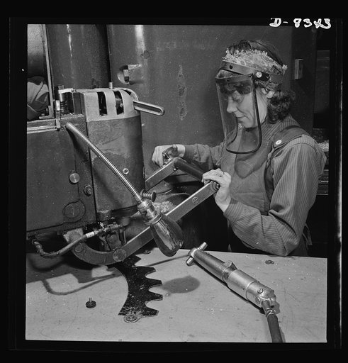 Production. B-17F heavy bomber. Mary Miller, operator of a router at the  Boeing plant in Seattle, drills holes in a part for a new B-17F (Flying Fortress) bomber. The Flying Fortress, a four-engine heavy bomber capable of flying at high altitudes, has performed with great credit in the South Pacifi