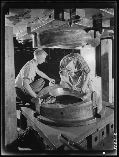 Production. B-17F heavy bomber. Kirksite dies for the forming of parts for new B-17F (Flying Fortress) bombers are finished in a hydraulic press at the Boeing plant in Seattle. The Flying Fortress, a four-engine heavy bomber capable of flying at high altitudes, has performed with great credit in the