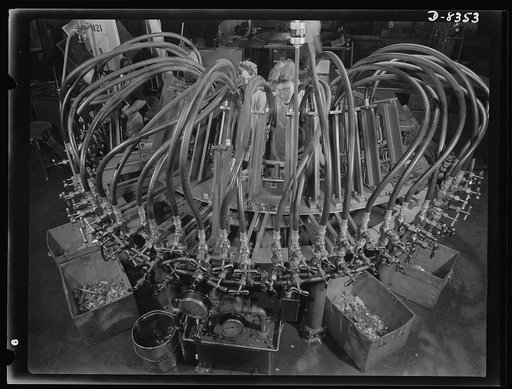 Production. B-17F heavy bomber. Octopus punching machine working on parts for new B-17F (Flying Fortress) bombers at the Boeing plant in Seattle. The Flying Fortress, a four-engine heavy bomber capable of flying at high altitudes, has performed with great credit in the South Pacific, over Germany an