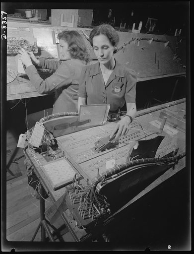 Production. B-17F heavy bomber. Checking electrical wiring assemblies for B-17F (Flying Fortress) bombers at the Boeing plant in Seattle. The Flying Fortress, a four-engine heavy bomber capable of flying at high altitudes, has performed with great credit in the South Pacific, over Germany and elsewh