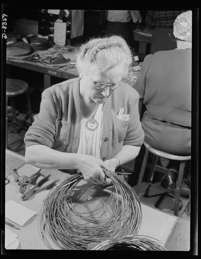 Production. B-17F heavy bomber. At the big Boeing plant in Seattle a woman worker applies identifying numbers to electrical conductor wires to be used in B-17F (Flying Fortress) bombers. The Flying Fortress, a four-engine heavy bomber capable of flying at high altitudes, has performed with great cre