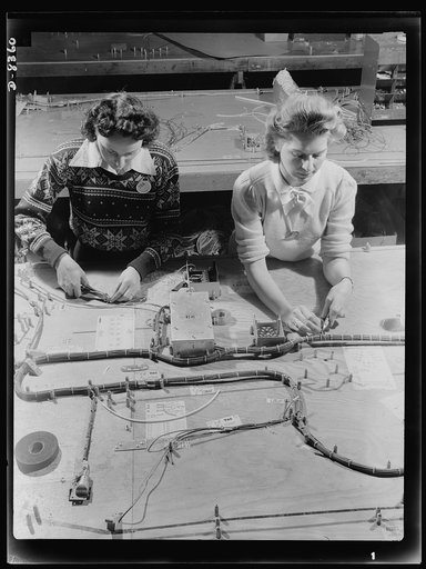Production. B-17F heavy bomber. Electrical wiring assemblies for B-17F (Flying Fortress) bombers are made up on forming boards at the Boeing plant in Seattle. The Flying Fortress, a four-engine heavy bomber capable of flying at high altitudes, has performed with great credit in the South Pacific, ov