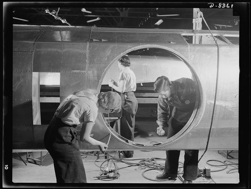 Production. B-17F heavy bomber. Working on the roof of a B-17F (Flying Fortress) bomber swung over on its side in the Boeing plant at Seattle. A turret will be mounted over the large circular opening. The Flying Fortress, a four-engine heavy bomber capable of flying at high altitudes, has performed 