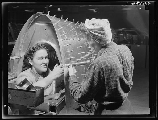 Production. B-17F heavy bomber. Woman riveting team working on a B-17F (Flying Fortress) bomber in the Boeing plant at Seattle. Over half the workers in this plant are women. The Flying Fortress, a four-engine heavy bomber capable of flying at high altitudes, has performed with great credit in the S