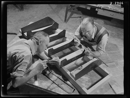 Production. B-17F heavy bomber. G.H. Knight and A. Johnson prepare the base for a plastic pattern of parts for B-17F (Flying Fortress) bombers at the Boeing plant at Seattle. The patterns will be reproduced on a Kellar machine. The Flying Fortress, a four-engine heavy bomber capable of flying at hig