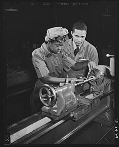 From NYA to Washington Navy Yard. Under the direction of Cecil M. Coles, NYA foreman Miss Juanita E. Gray learns to operate a lathe machine at the Washington, D.C. National Youth Administration War Production and Training Center. This former domestic worker is one of hundreds of Negro women trained 