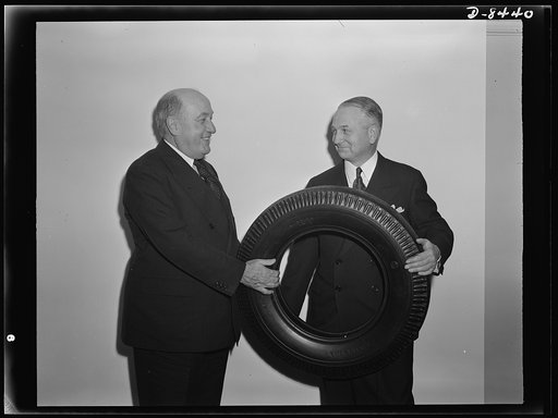 Tire made entirely of reclaimed rubber. F.S. Carpenter, of the United States Company, displays an automobile tire made entirely of reclaimed rubber to William M. Jeffers, War Production Board (WPB) director