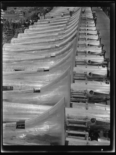 Production. B-17 heavy bomber. Tail sections of B-17F (Flying Fortress) bombers ready for assembly into the big warships of the air at the Boeing plant in Seattle. The Flying Fortress has performed with great credit in the South Pacific, over Germany and elsewhere. It is a four-engine, heavy bomber 
