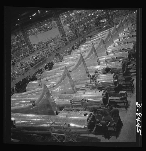 Production. B-17 heavy bomber. Tail sections of B-17F (Flying Fortress) bombers ready for assembly into the big warships of the air at the Boeing plant in Seattle. The Flying Fortress has performed with great credit in the South Pacific, over Germany and elsewhere. It is a four-engine, heavy bomber 