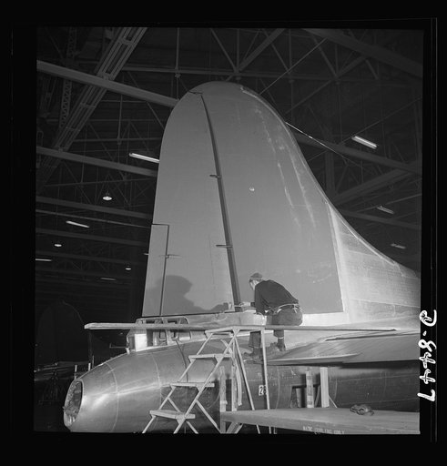 Production. B-17 heavy bomber. The tail and rudder of a mighty B-17F (Flying Fortress) bomber near completion at the Boeing plant in Seattle.  The Flying Fortress has performed with great credit in the South Pacific, over Germany and elsewhere. It is a four-engine, heavy bomber capable of flying hig