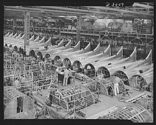 Production. B-17 heavy bomber. Fuselages frameworks for B-17F (Flying Fortress) bomber under construction at the Boeing plant in Seattle. In the background are tail sections with distinctive B-17F dorsal fins. The Flying Fortress has performed with great credit in the South Pacific, over Germany and