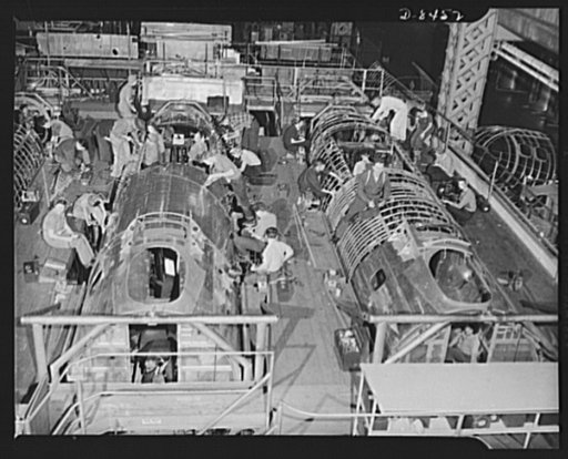 Production. B-17 heavy bomber. Fast, expert workers at the Boeing plant in Seattle apply outer "skins" to fuselage sections for new B-17F (Flying Fortress) bombers, while assembly and fitting operations go forward in the interiors. The Flying Fortress has performed with great credit in the South Pac