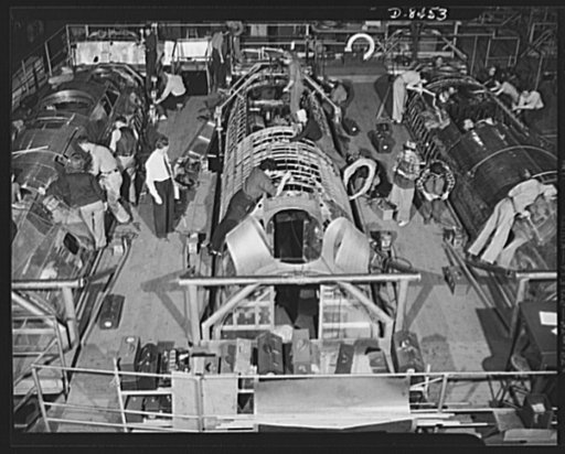 Production. B-17 heavy bomber. Fast, expert workers at the Boeing plant in Seattle apply outer "skins" to fuselage sections for new B-17F (Flying Fortress) bombers, while assembly and fitting operations go forward in the interiors. The Flying Fortress has performed with great credit in the South Pac